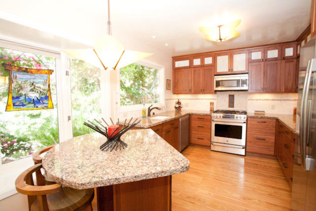 サンフランシスコにあるアジアンスタイルのおしゃれなアイランドキッチン (中間色木目調キャビネット、珪岩カウンター) の写真