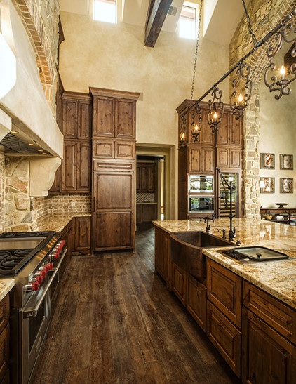 Exempel på ett mycket stort klassiskt kök, med en köksö, luckor med upphöjd panel, skåp i mörkt trä, granitbänkskiva, beige stänkskydd, stänkskydd i terrakottakakel, rostfria vitvaror, en rustik diskho och mörkt trägolv