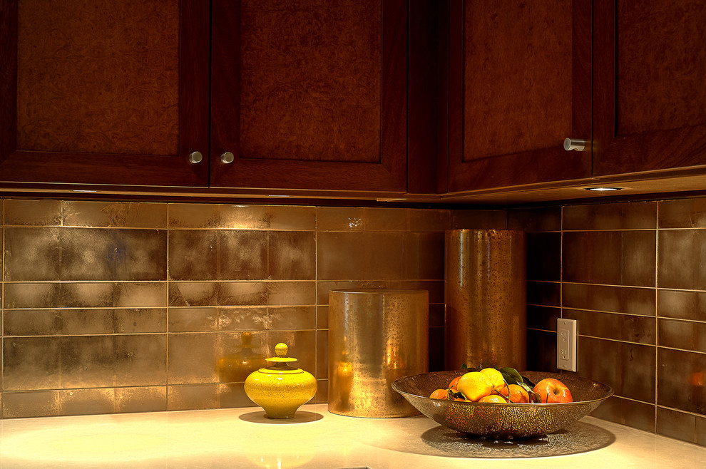 Huge elegant u-shaped limestone floor enclosed kitchen photo in Los Angeles with a double-bowl sink, shaker cabinets, dark wood cabinets, granite countertops, metallic backsplash, glass tile backsplash, stainless steel appliances and an island