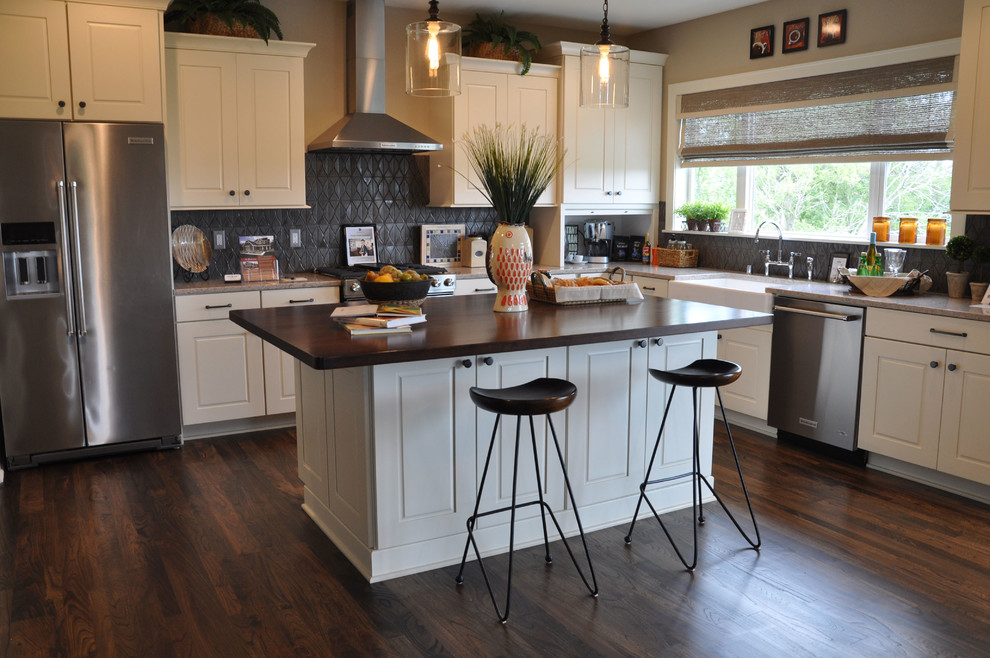 Large island style l-shaped dark wood floor and brown floor eat-in kitchen photo in Milwaukee with recessed-panel cabinets, white cabinets, gray backsplash, stainless steel appliances, an island, a farmhouse sink, granite countertops and ceramic backsplash