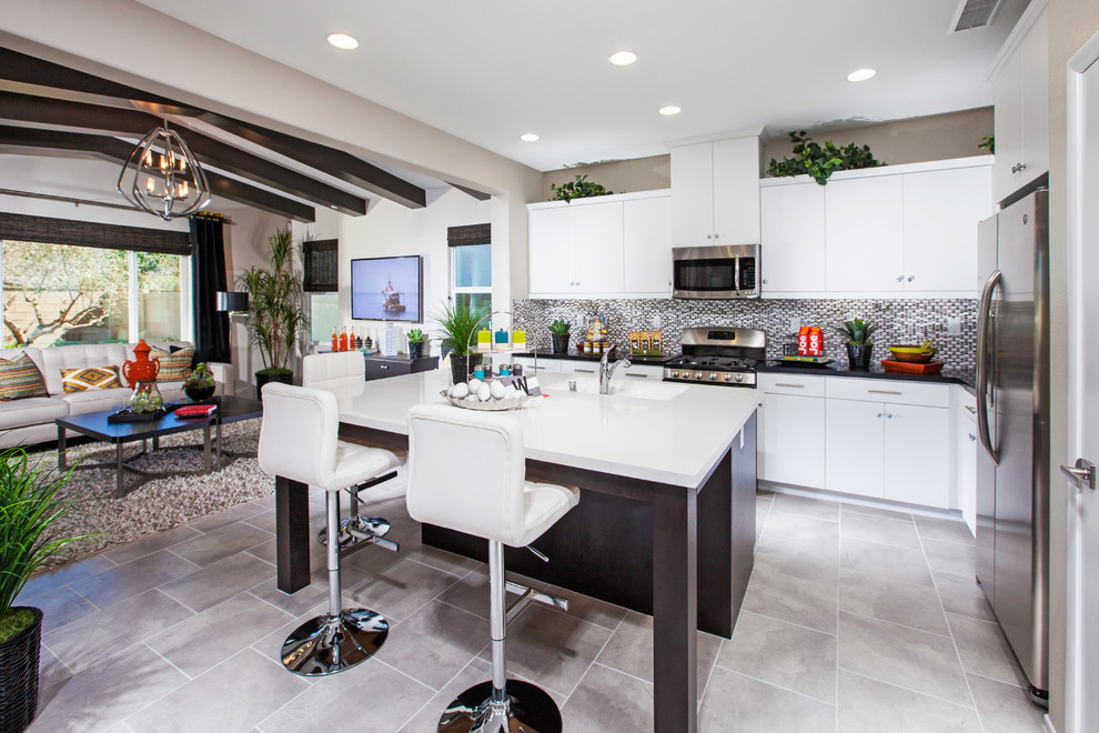 Inspiration for a mid-sized contemporary l-shaped ceramic tile and gray floor open concept kitchen remodel in Los Angeles with flat-panel cabinets, white cabinets, granite countertops, stainless steel appliances, an island, an undermount sink, multicolored backsplash and mosaic tile backsplash