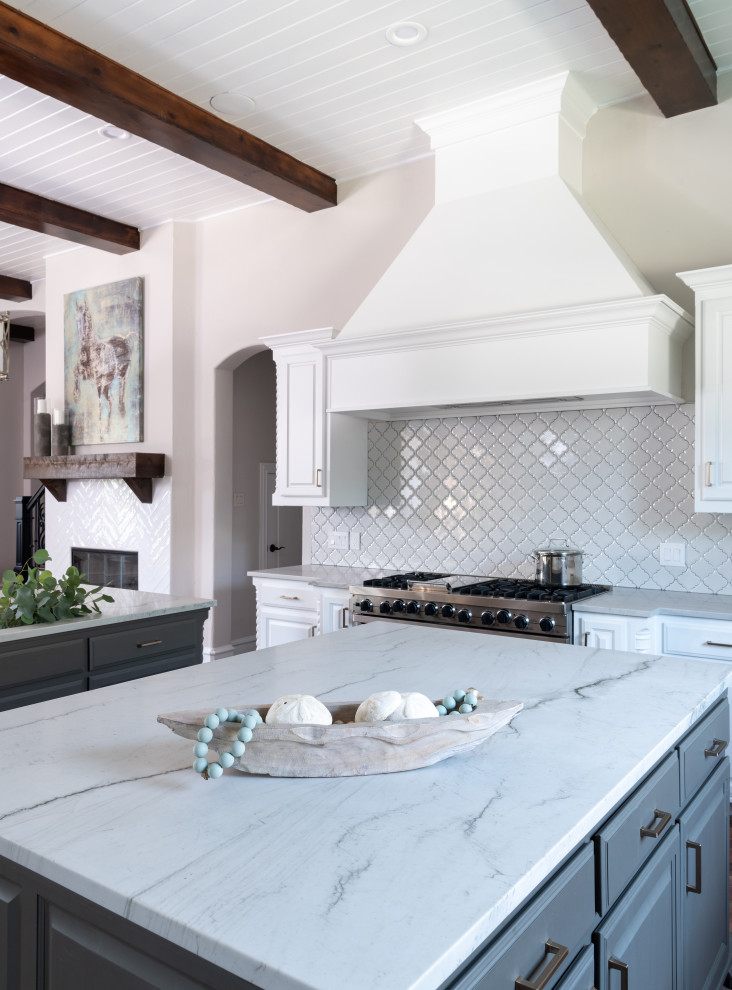 Classic kitchen in Dallas with raised-panel cabinets, white cabinets, white splashback, stainless steel appliances, brick flooring, multiple islands and white worktops.