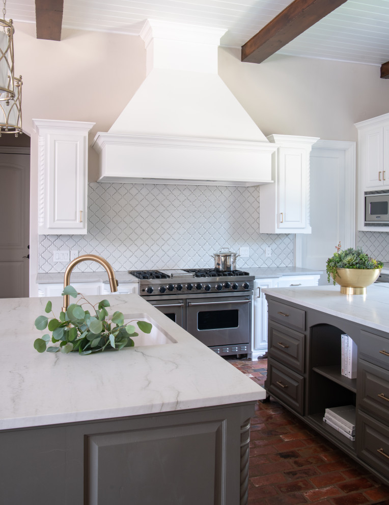 Transitional brick floor kitchen photo in Dallas with raised-panel cabinets, white cabinets, white backsplash, stainless steel appliances, two islands and white countertops