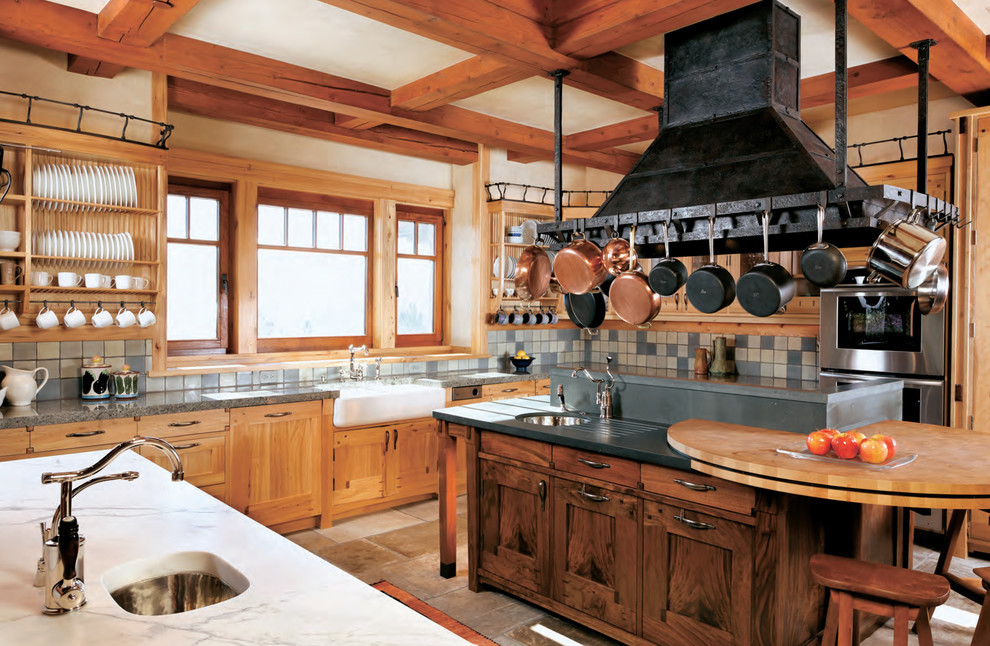 This is an example of an expansive rustic u-shaped kitchen in San Francisco with stainless steel appliances, a belfast sink, shaker cabinets, ceramic flooring and multiple islands.