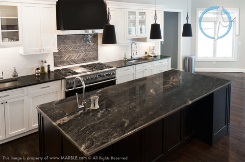 Modern Canadian kitchen with black granite countertop island and white cabinets for Quartz vs Granite Countertops comparison