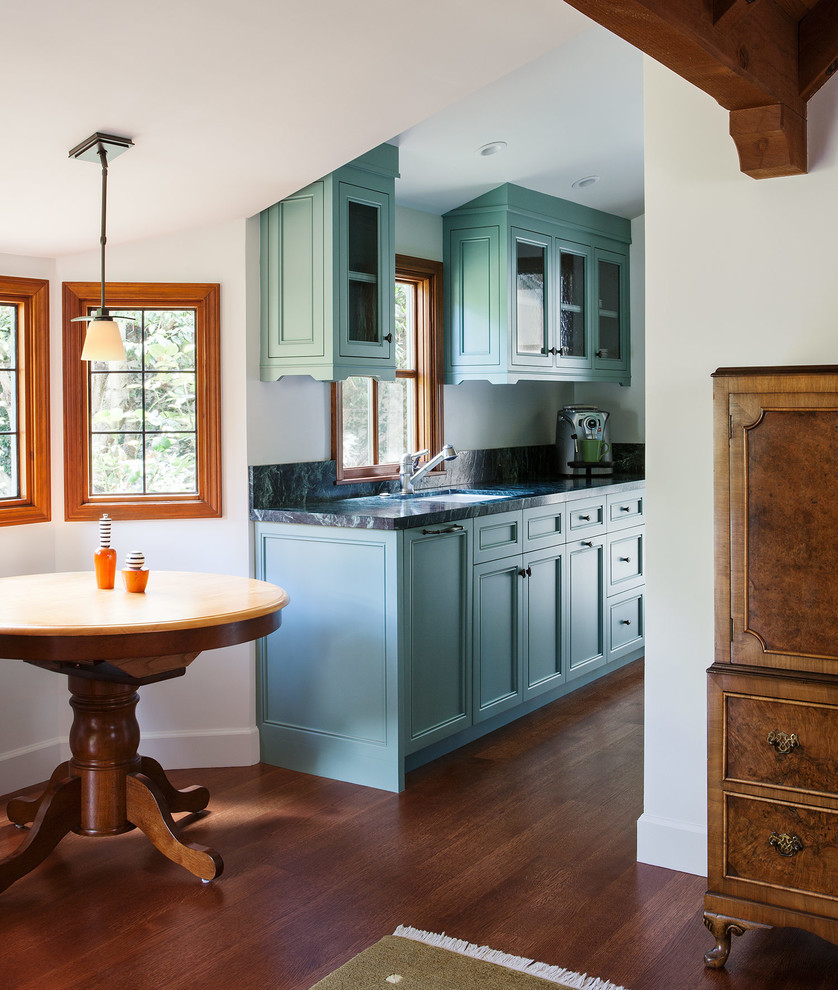 This is an example of a small mediterranean kitchen in San Francisco with a submerged sink, recessed-panel cabinets, blue cabinets, dark hardwood flooring, marble worktops and grey splashback.