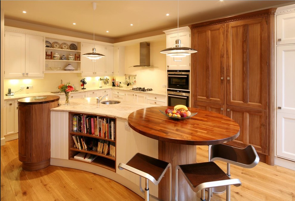 Design ideas for a large traditional l-shaped kitchen/diner in Edinburgh with a double-bowl sink, beaded cabinets, white cabinets, granite worktops, stainless steel appliances, light hardwood flooring, an island and white splashback.