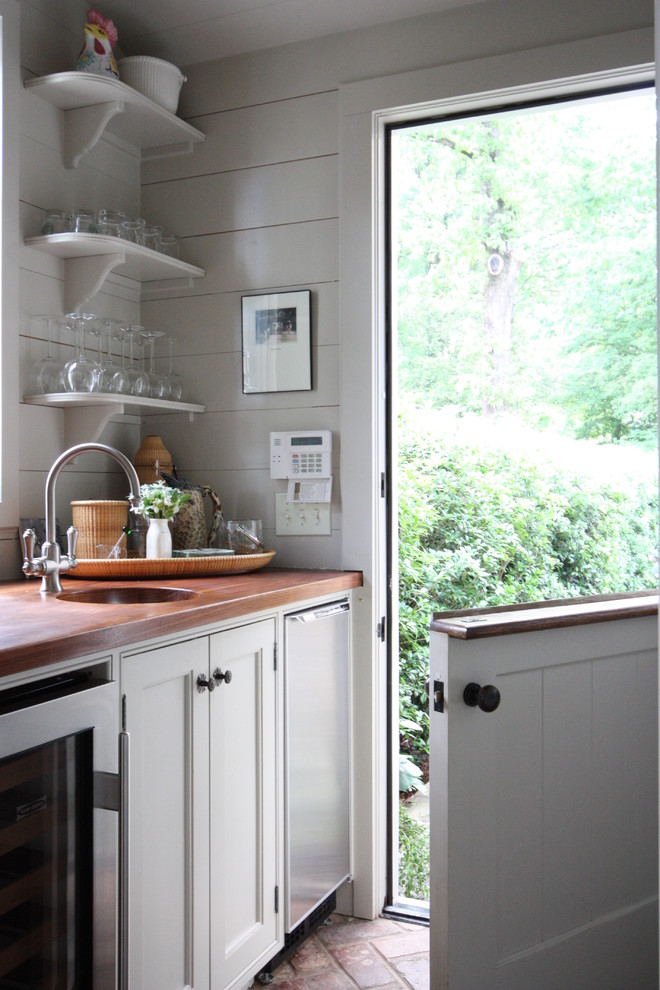 Inspiration for a traditional kitchen in Atlanta with open cabinets, white cabinets and stainless steel appliances.