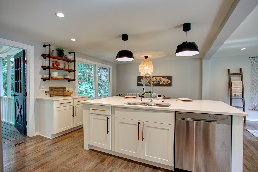 Idéer för ett mellanstort modernt vit linjärt kök och matrum, med en undermonterad diskho, skåp i shakerstil, vita skåp, bänkskiva i kvarts, rostfria vitvaror, korkgolv, en köksö och brunt golv