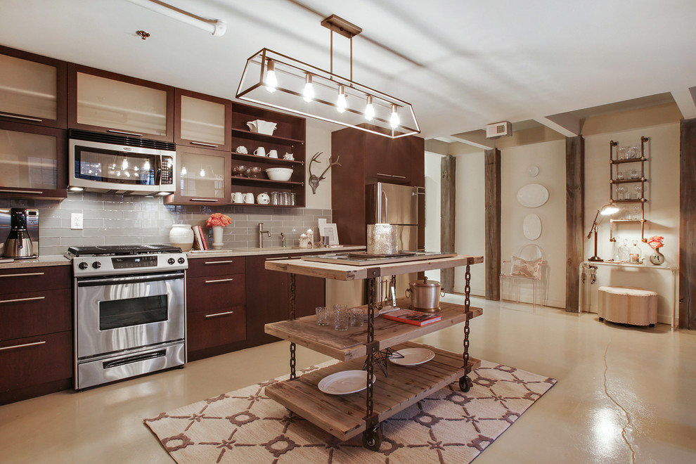 Kitchen - rustic kitchen idea in Atlanta with flat-panel cabinets, dark wood cabinets, beige backsplash, subway tile backsplash, stainless steel appliances and an island