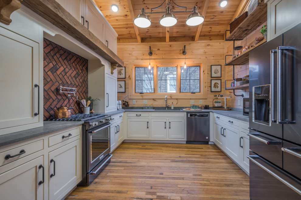 Inspiration for a rustic u-shaped medium tone wood floor, brown floor, exposed beam, vaulted ceiling and wood ceiling kitchen remodel in Atlanta with an undermount sink, shaker cabinets, gray cabinets, brown backsplash, wood backsplash, stainless steel appliances, no island and gray countertops