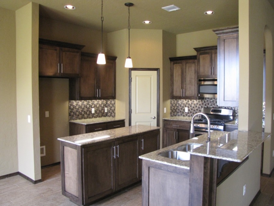 Inspiration for a timeless l-shaped ceramic tile kitchen pantry remodel in Oklahoma City with raised-panel cabinets, medium tone wood cabinets, marble countertops, beige backsplash and an island
