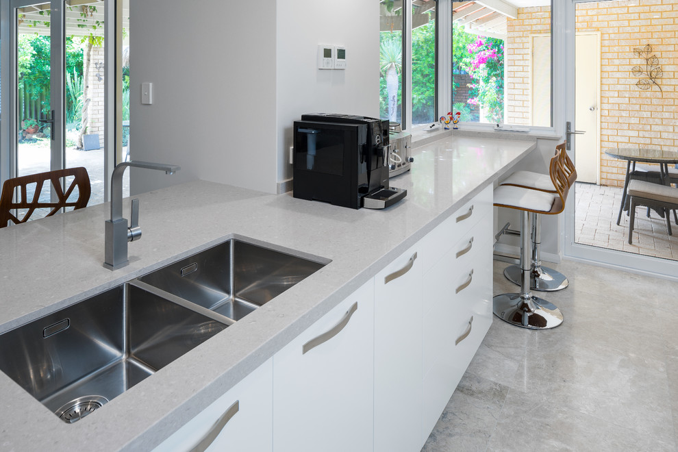 Minimalist kitchen photo in Perth with an undermount sink, flat-panel cabinets, white cabinets, quartz countertops, stainless steel appliances and gray countertops