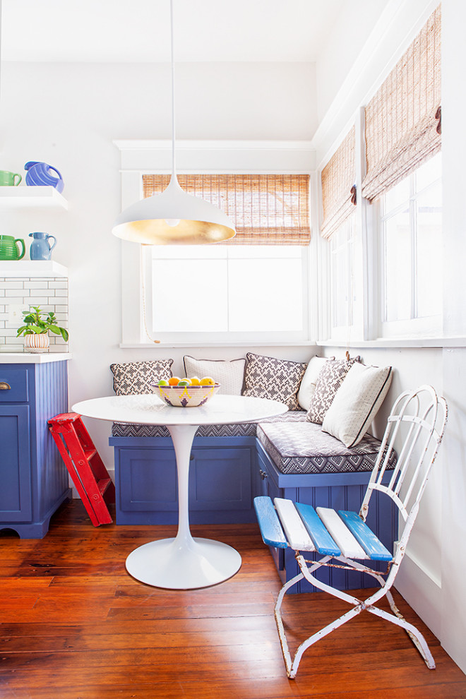 Example of a mid-sized arts and crafts l-shaped dark wood floor and brown floor enclosed kitchen design in Los Angeles with shaker cabinets, blue cabinets, quartz countertops, white backsplash, ceramic backsplash, an island and white countertops
