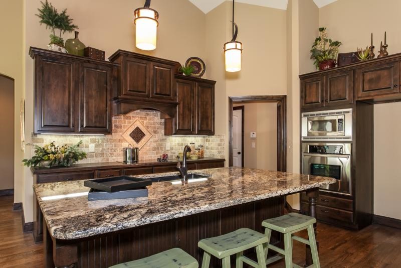 This is an example of a country kitchen in Wichita with raised-panel cabinets.