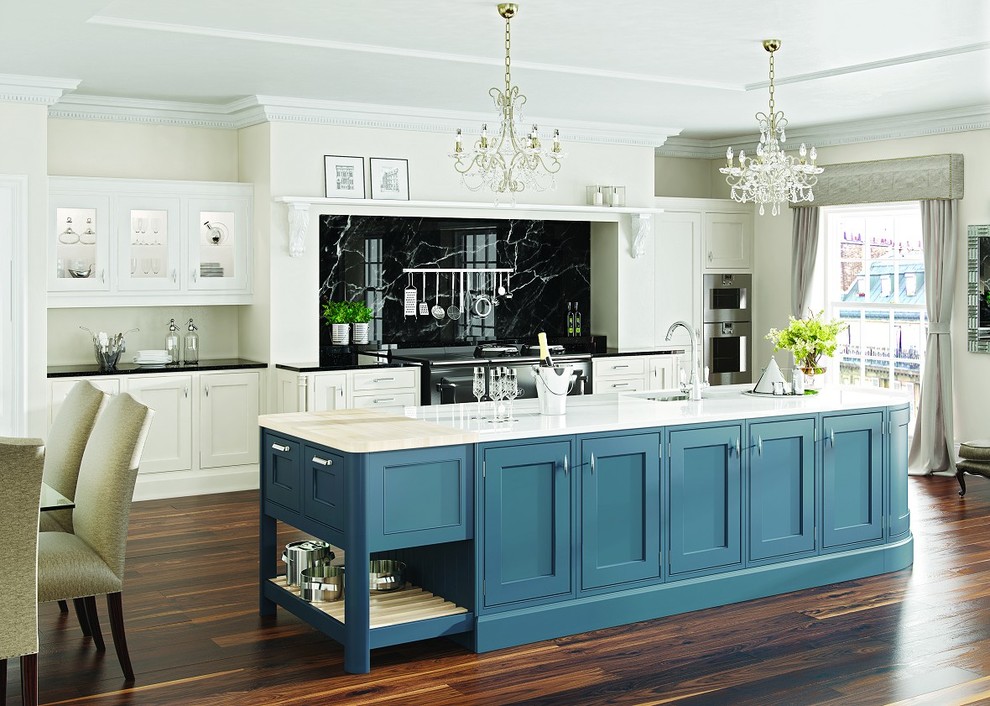 Design ideas for a large traditional galley open plan kitchen in Cambridgeshire with a belfast sink, shaker cabinets, medium wood cabinets, marble worktops, multi-coloured splashback, stone slab splashback, integrated appliances, medium hardwood flooring and an island.