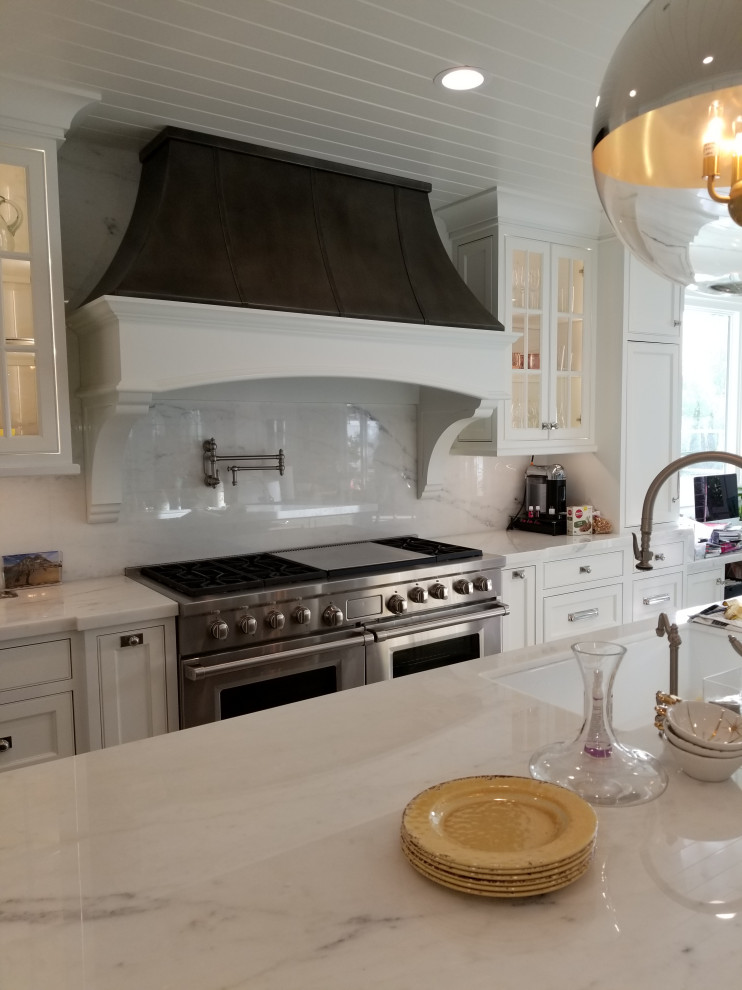 Large eclectic l-shaped porcelain tile, white floor and shiplap ceiling eat-in kitchen photo in Orange County with a drop-in sink, shaker cabinets, white cabinets, marble countertops, white backsplash, marble backsplash, stainless steel appliances, an island and white countertops