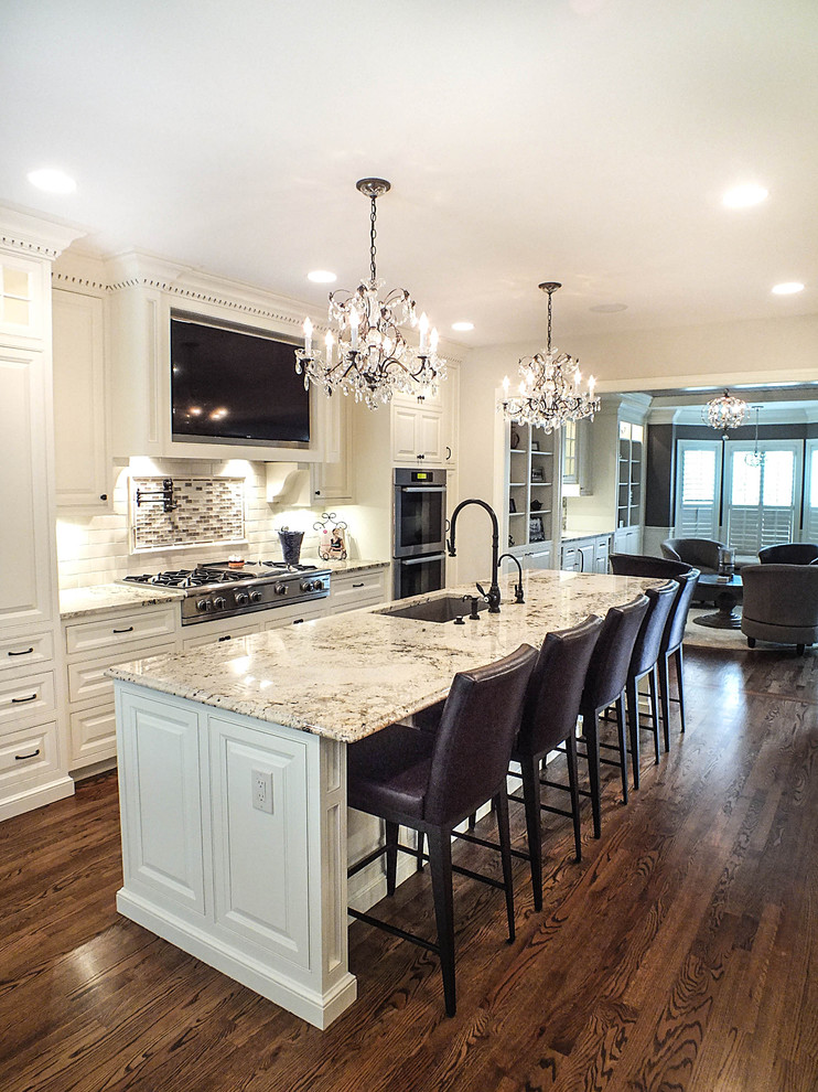 Inspiration for a large timeless galley dark wood floor eat-in kitchen remodel in Cleveland with a single-bowl sink, raised-panel cabinets, white cabinets, granite countertops, white backsplash, glass tile backsplash, stainless steel appliances and an island