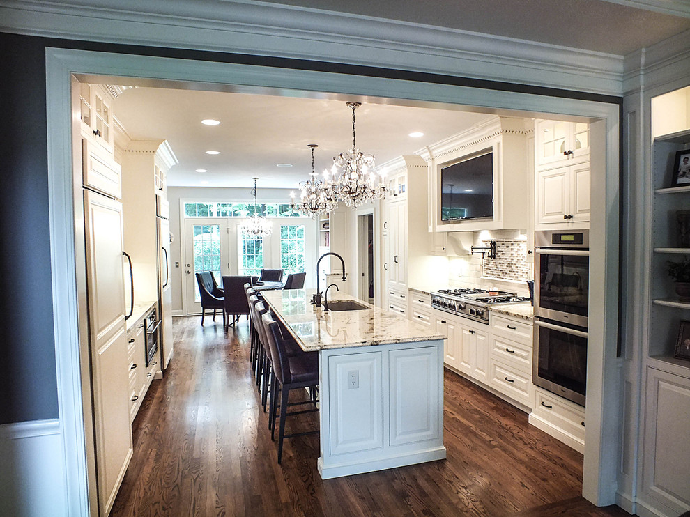 Eat-in kitchen - large traditional galley dark wood floor eat-in kitchen idea in Cleveland with a single-bowl sink, raised-panel cabinets, white cabinets, granite countertops, white backsplash, glass tile backsplash, stainless steel appliances and an island