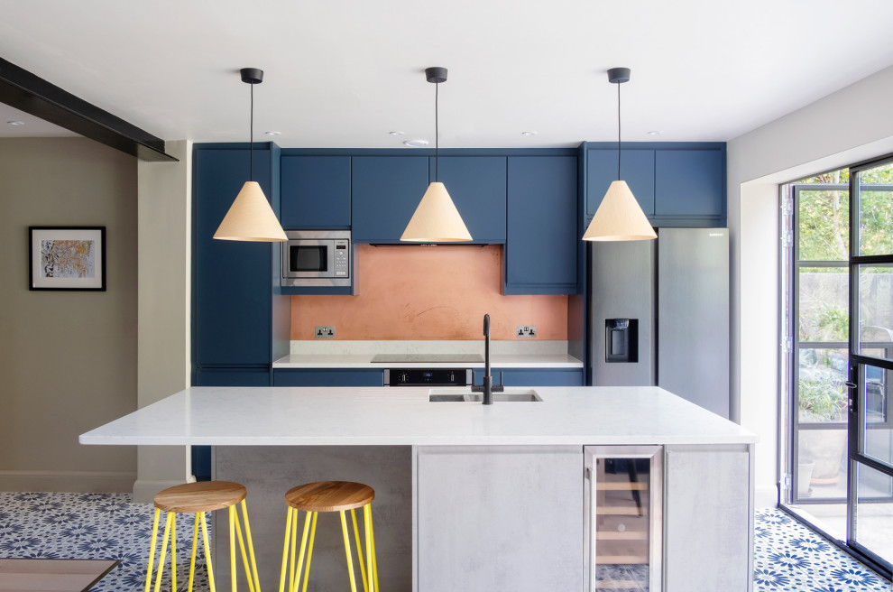 Foto de cocina contemporánea con fregadero bajoencimera, armarios con paneles lisos, puertas de armario azules, una isla, suelo azul y encimeras blancas