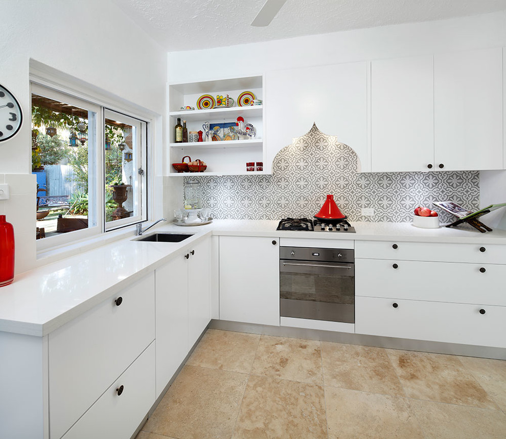 Inspiration for a small contemporary l-shaped travertine floor enclosed kitchen remodel in Sydney with a single-bowl sink, flat-panel cabinets, white cabinets, multicolored backsplash, ceramic backsplash, stainless steel appliances and no island
