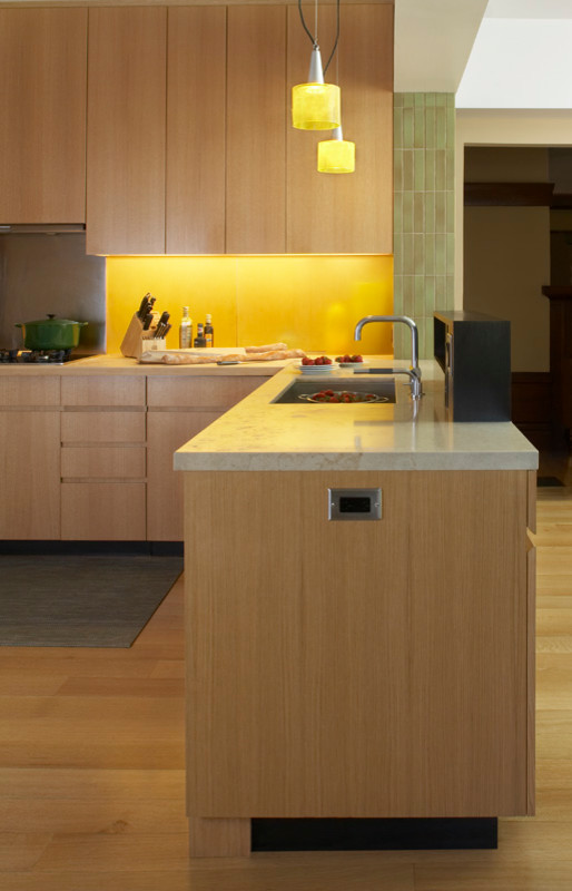 Inspiration for a mid-sized modern u-shaped light wood floor and beige floor eat-in kitchen remodel in San Francisco with an integrated sink, flat-panel cabinets, light wood cabinets, multicolored backsplash, stainless steel appliances, a peninsula and beige countertops