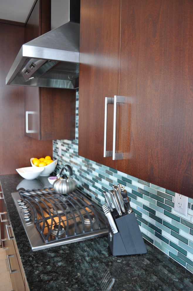 Example of a large trendy galley ceramic tile eat-in kitchen design in New York with an undermount sink, flat-panel cabinets, medium tone wood cabinets, granite countertops, multicolored backsplash, glass tile backsplash, stainless steel appliances and two islands