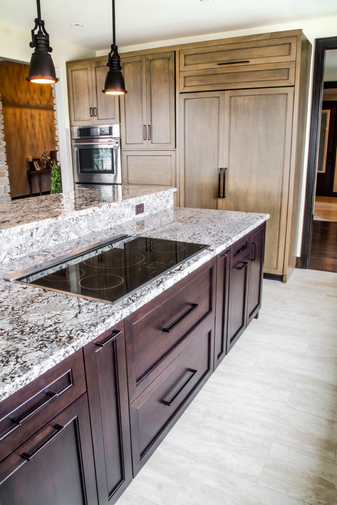 This is an example of an expansive contemporary kitchen in Other with a submerged sink, recessed-panel cabinets, distressed cabinets, granite worktops, stainless steel appliances, ceramic flooring and an island.