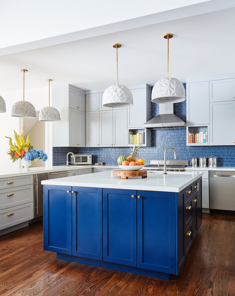 Design ideas for a large traditional l-shaped open plan kitchen in San Francisco with a submerged sink, shaker cabinets, blue cabinets, engineered stone countertops, blue splashback, ceramic splashback, stainless steel appliances, medium hardwood flooring, an island and white worktops.