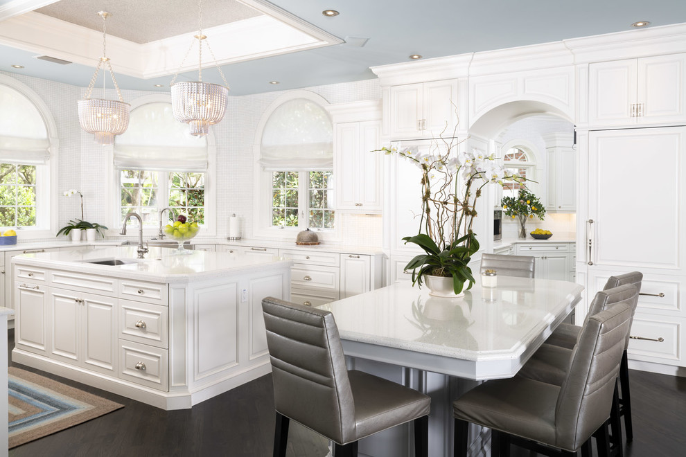 Eat-in kitchen - traditional l-shaped dark wood floor eat-in kitchen idea in Tampa with a single-bowl sink, raised-panel cabinets, white cabinets, white backsplash, an island and white countertops