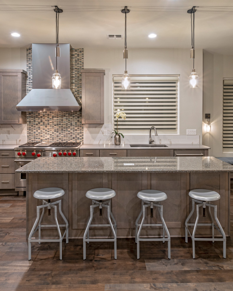 Eat-in kitchen - large transitional l-shaped laminate floor and brown floor eat-in kitchen idea in Austin with an undermount sink, shaker cabinets, gray cabinets, quartz countertops, white backsplash, porcelain backsplash, stainless steel appliances, two islands and gray countertops