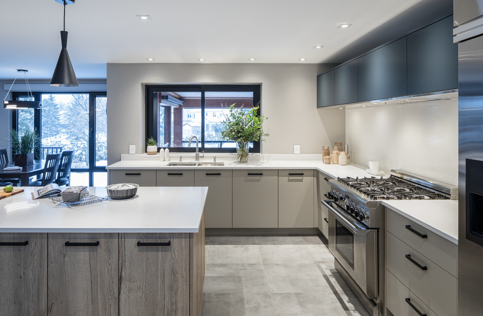 Inspiration for a medium sized contemporary l-shaped kitchen/diner in Ottawa with a submerged sink, flat-panel cabinets, grey cabinets, engineered stone countertops, white splashback, stone slab splashback, stainless steel appliances, porcelain flooring, an island and grey floors.