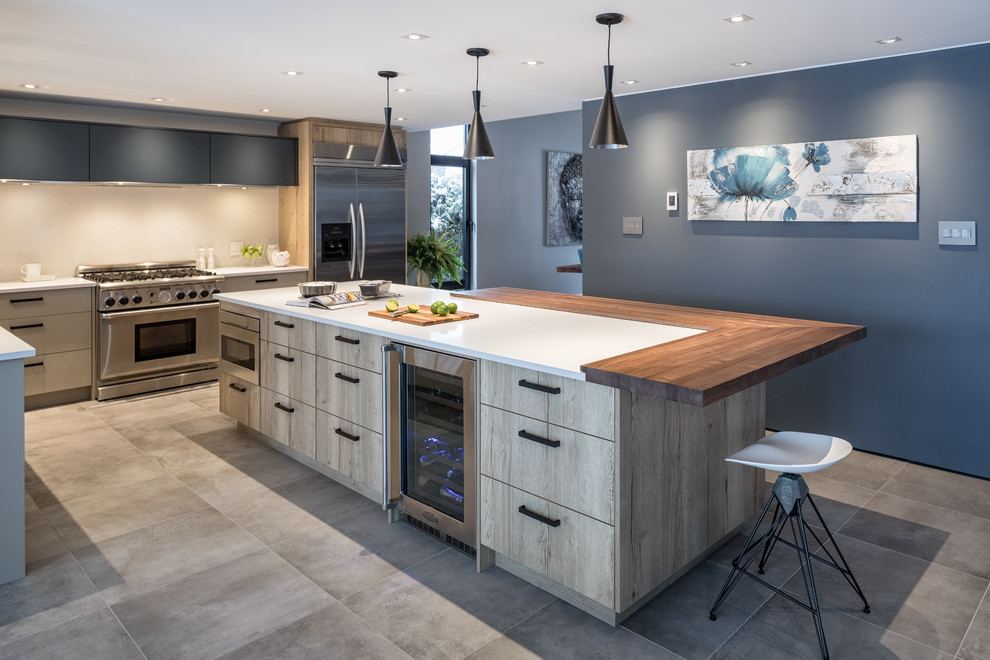Medium sized contemporary l-shaped kitchen/diner in Ottawa with a submerged sink, flat-panel cabinets, grey cabinets, engineered stone countertops, white splashback, stone slab splashback, stainless steel appliances, porcelain flooring, an island and grey floors.
