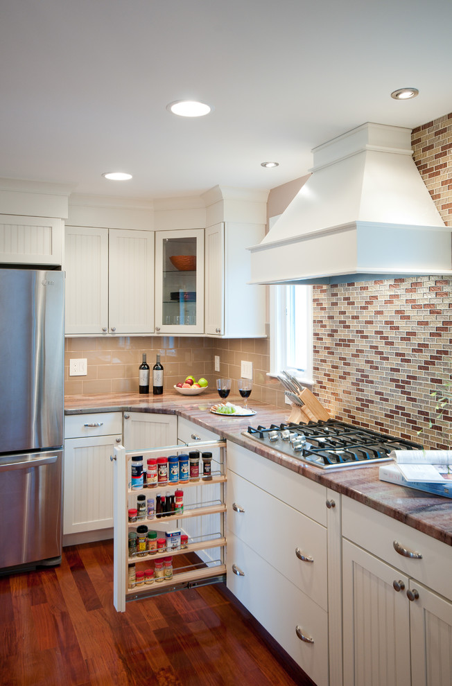 Example of a large classic u-shaped medium tone wood floor eat-in kitchen design in Providence with an undermount sink, shaker cabinets, white cabinets, granite countertops, beige backsplash, subway tile backsplash, stainless steel appliances and a peninsula