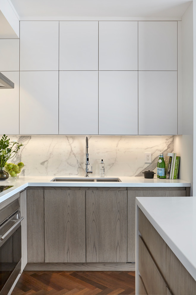 Inspiration for a medium sized modern l-shaped open plan kitchen in Toronto with a submerged sink, flat-panel cabinets, engineered stone countertops, white splashback, porcelain splashback, integrated appliances, dark hardwood flooring and an island.