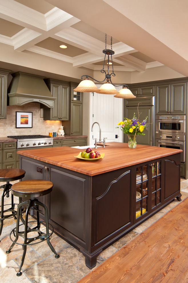 Kitchen - traditional kitchen idea in Other with raised-panel cabinets, green cabinets, beige backsplash, stainless steel appliances and an island