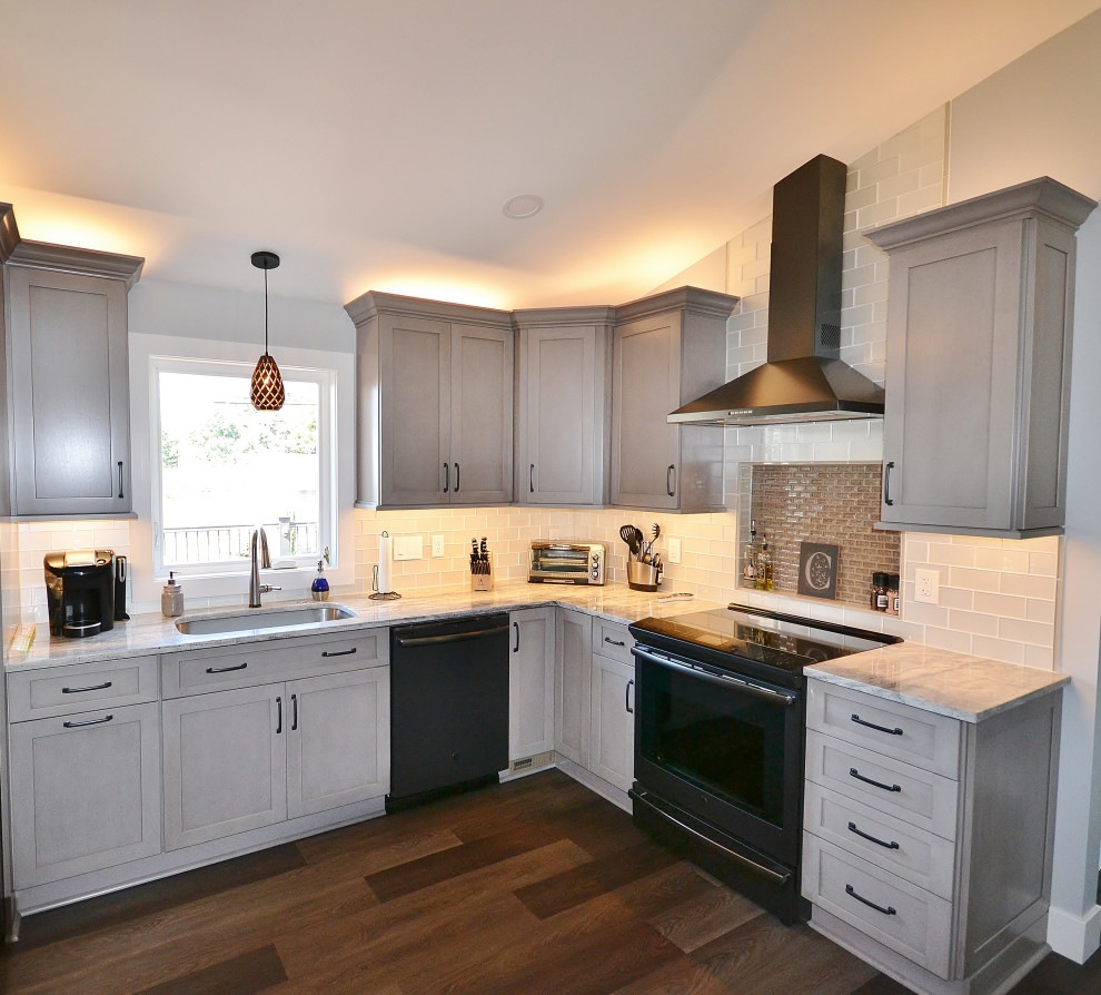 Example of a large transitional vinyl floor and brown floor eat-in kitchen design in Philadelphia with an undermount sink, recessed-panel cabinets, gray cabinets, granite countertops, white backsplash, subway tile backsplash, stainless steel appliances, an island and white countertops