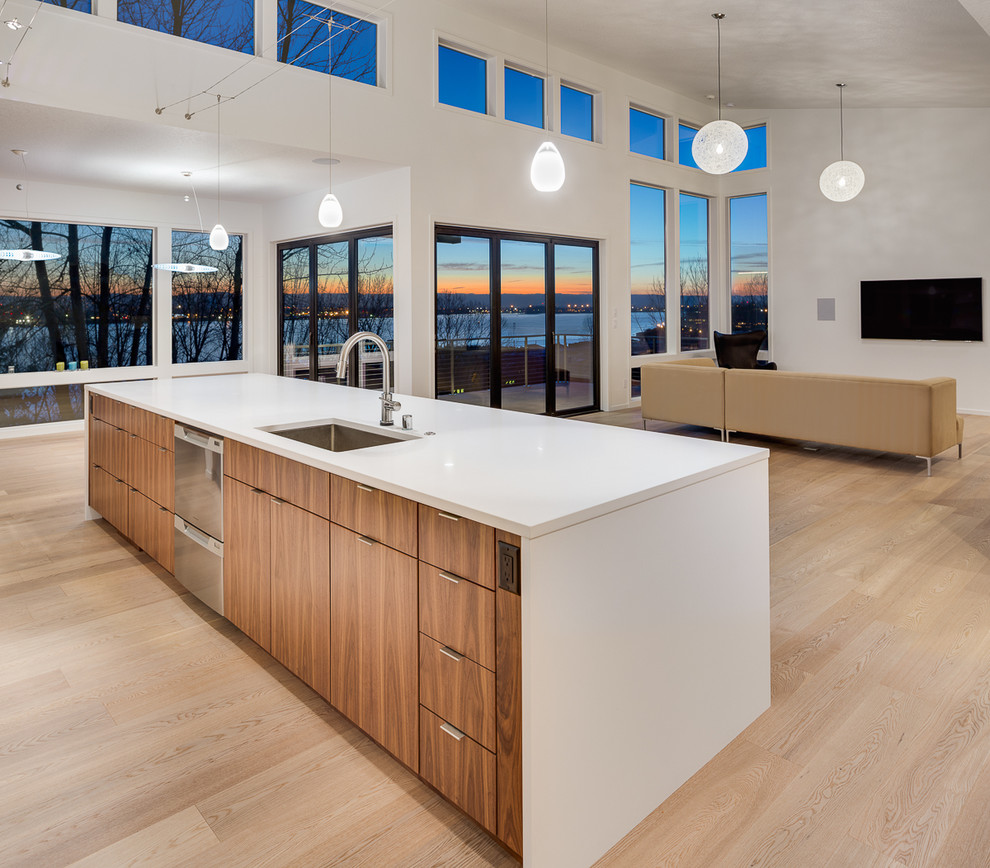 Example of a large minimalist galley light wood floor eat-in kitchen design in Portland with an undermount sink, flat-panel cabinets, medium tone wood cabinets, quartz countertops, white backsplash, glass tile backsplash, stainless steel appliances and an island