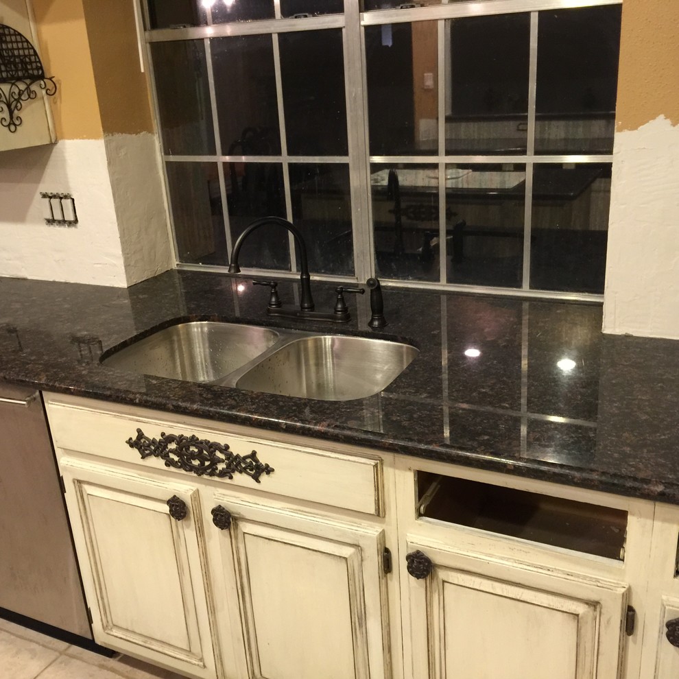 Inspiration for a medium sized classic l-shaped open plan kitchen in Houston with a submerged sink, recessed-panel cabinets, distressed cabinets, granite worktops, white appliances, ceramic flooring, an island and beige floors.