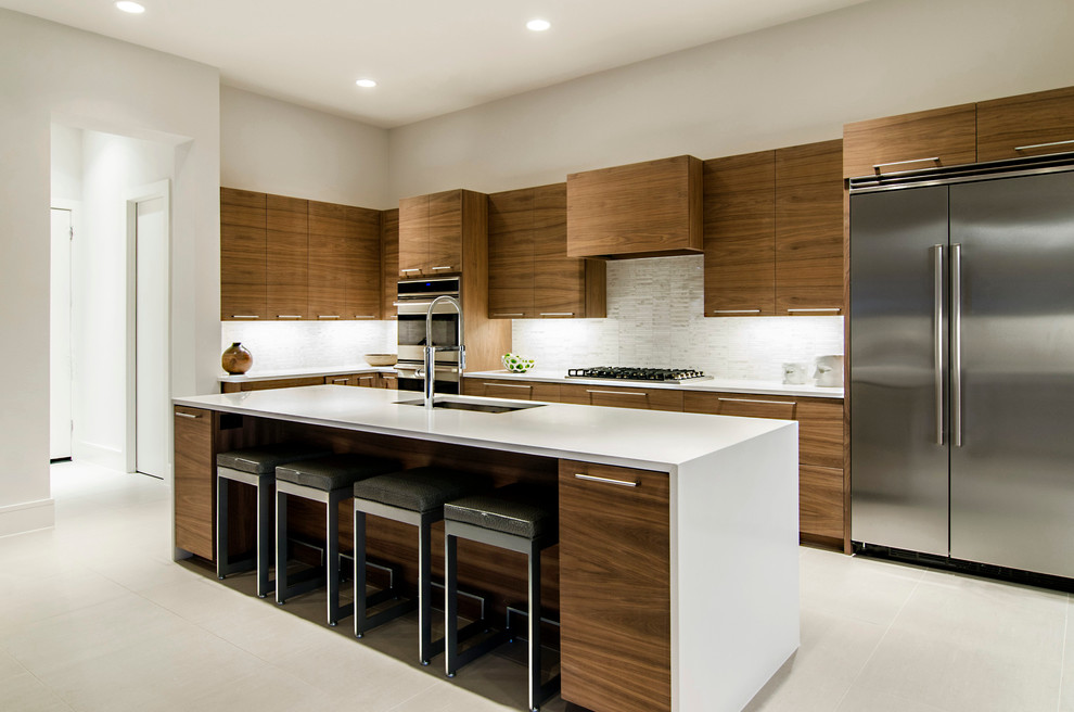 This is an example of a modern kitchen in Dallas with matchstick tiled splashback and stainless steel appliances.