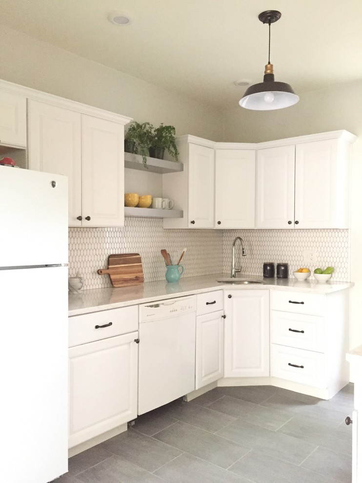 Inspiration for a medium sized traditional l-shaped enclosed kitchen in Boston with a built-in sink, shaker cabinets, white cabinets, engineered stone countertops, white splashback, mosaic tiled splashback, stainless steel appliances, slate flooring, no island and grey floors.