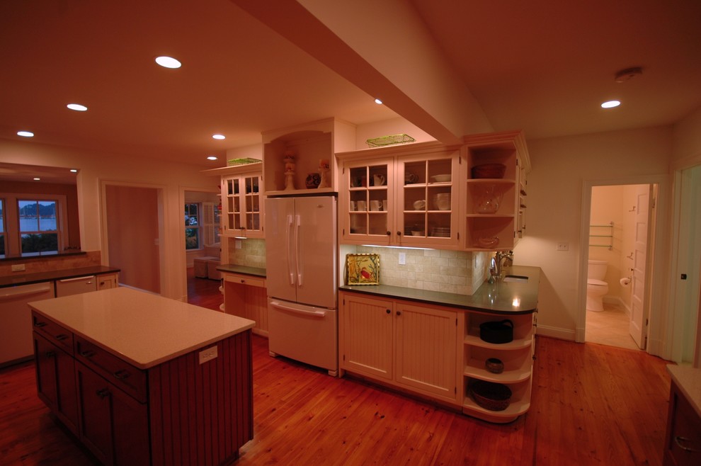 Mid-sized eclectic u-shaped light wood floor eat-in kitchen photo in DC Metro with an undermount sink, shaker cabinets, white cabinets, quartz countertops, beige backsplash, stone tile backsplash, white appliances and an island