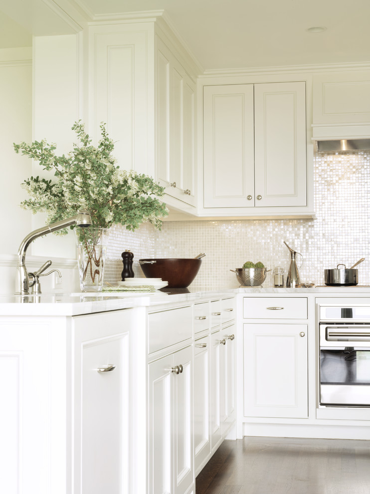 Inspiration for a timeless kitchen remodel in Boston with stainless steel appliances, recessed-panel cabinets, white cabinets and white backsplash