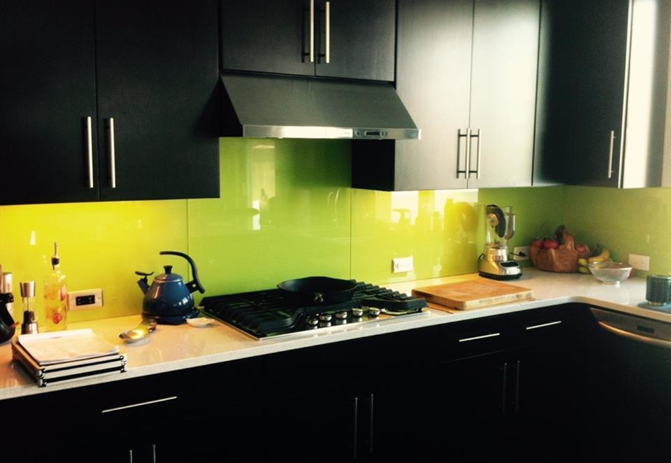 Eklektische Wohnküche mit flächenbündigen Schrankfronten, schwarzen Schränken, Quarzwerkstein-Arbeitsplatte, Küchenrückwand in Grün, Glasrückwand und Küchengeräten aus Edelstahl in Denver