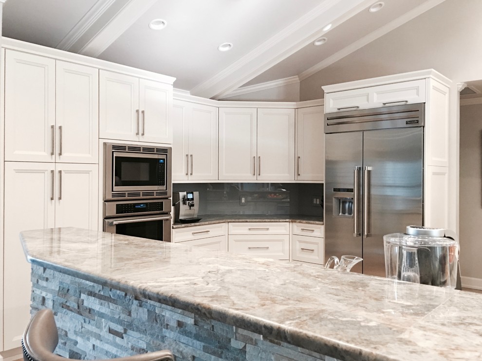 Inspiration for a large transitional single-wall open concept kitchen remodel in Miami with a drop-in sink, recessed-panel cabinets, white cabinets, marble countertops, gray backsplash, glass sheet backsplash, stainless steel appliances and an island