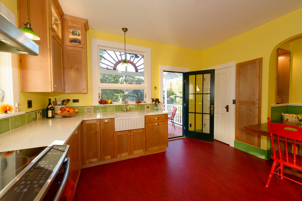 Example of a mid-sized arts and crafts u-shaped eat-in kitchen design in Portland with a farmhouse sink, shaker cabinets, medium tone wood cabinets, quartz countertops, green backsplash, ceramic backsplash, stainless steel appliances and no island
