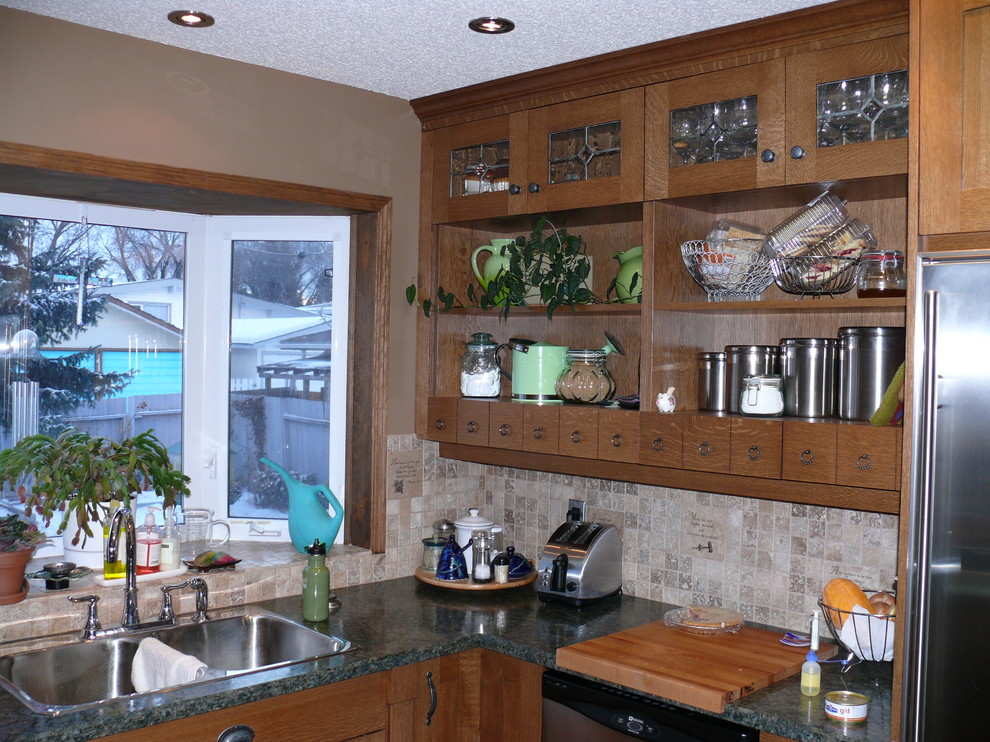 Design ideas for a small classic u-shaped kitchen/diner in Calgary with shaker cabinets, medium wood cabinets, a breakfast bar, a built-in sink, laminate countertops, beige splashback, mosaic tiled splashback, stainless steel appliances and light hardwood flooring.