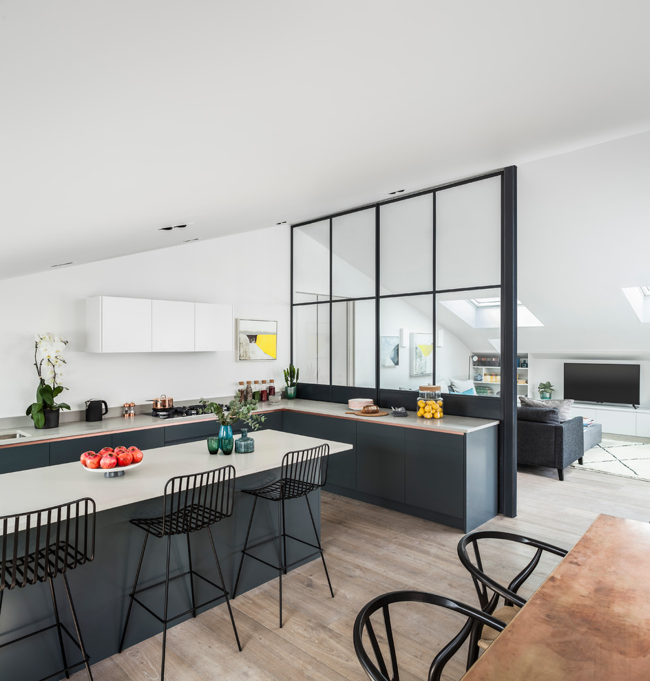 Inspiration for a contemporary l-shaped light wood floor kitchen remodel in London with an undermount sink, flat-panel cabinets, gray cabinets and an island