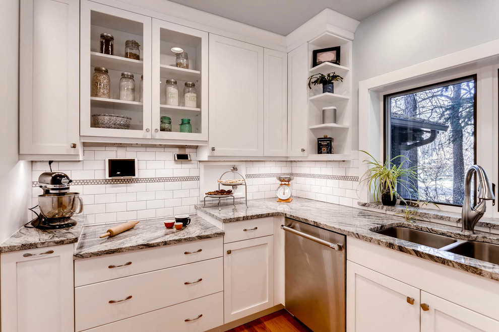 Inspiration for a medium sized traditional u-shaped enclosed kitchen in Denver with a submerged sink, shaker cabinets, white cabinets, granite worktops, white splashback, metro tiled splashback, stainless steel appliances, medium hardwood flooring and a breakfast bar.
