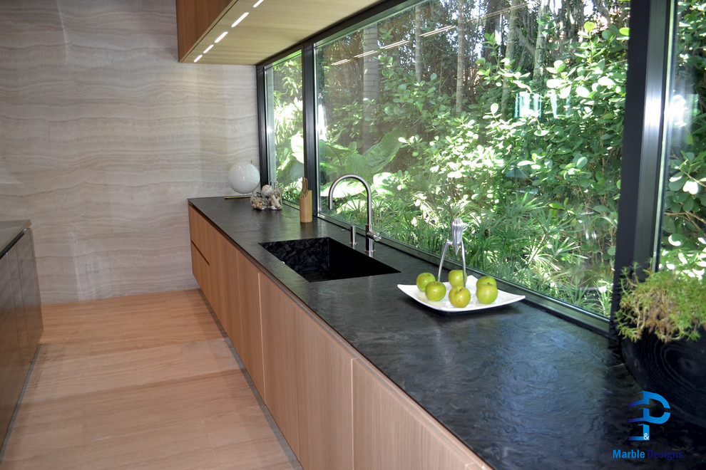 Idee per una cucina minimalista con lavello integrato, ante lisce, ante in legno chiaro, top in granito, elettrodomestici in acciaio inossidabile e pavimento in marmo